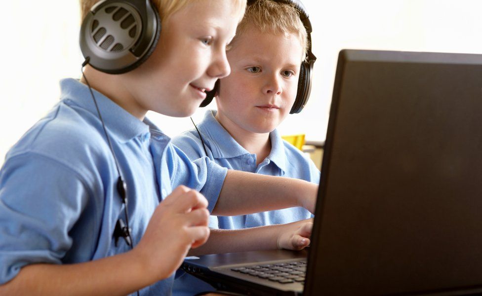 Generic picture of two boys using a laptop and smiling