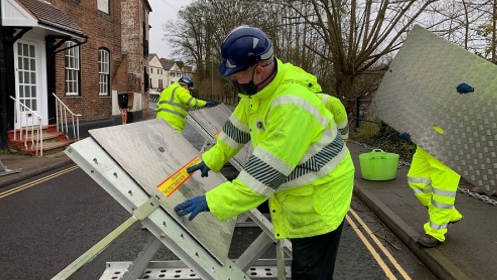 Men fixing flood defences