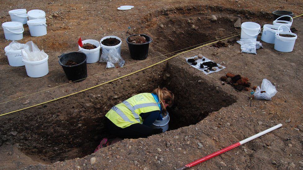 Archaeologist Sam Williamson excavating a grain-drying kiln at Torvean