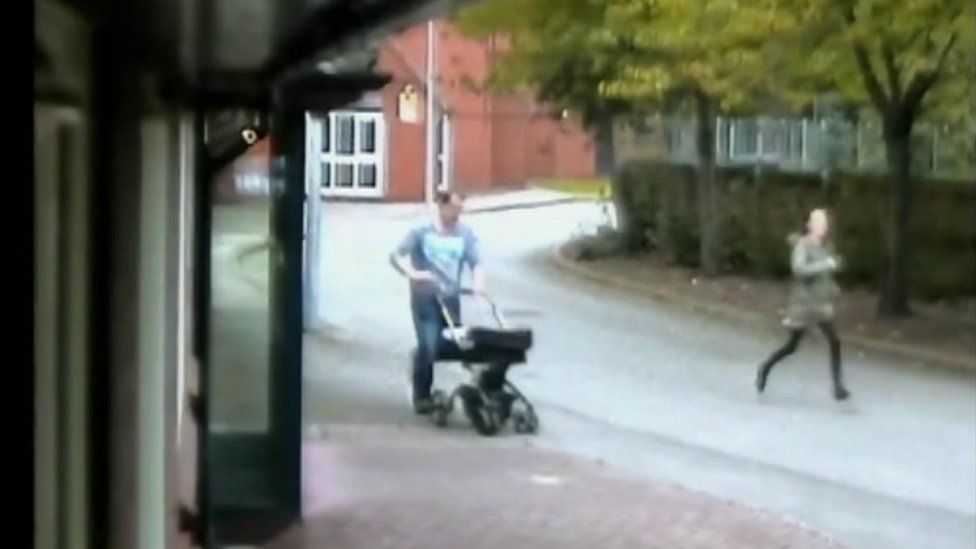 CCTV image of a father running while pushing a baby in a pram