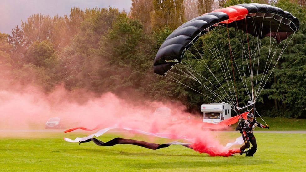 Parachute display team member landing