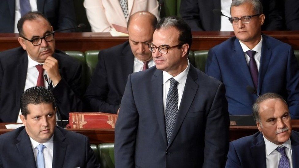 Slim Chaker attends a parliamentary session ahead of a vote of confidence in the prime minister"s reshuffled government, on September 11, 2017, in Tunis.