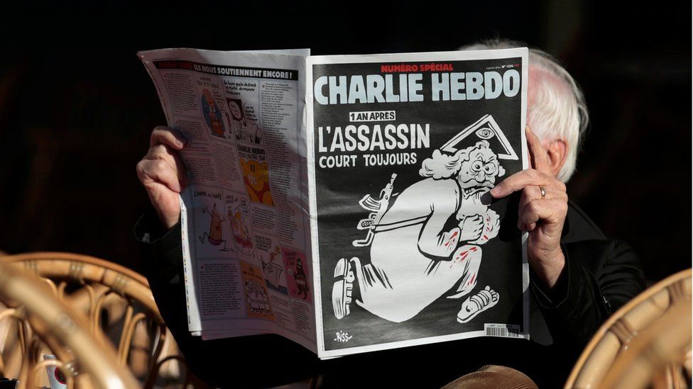 A man reads the special commemorative edition of French satirical newspaper Charlie Hebdo at a Cafe in Nice, on January 6th, 2016.