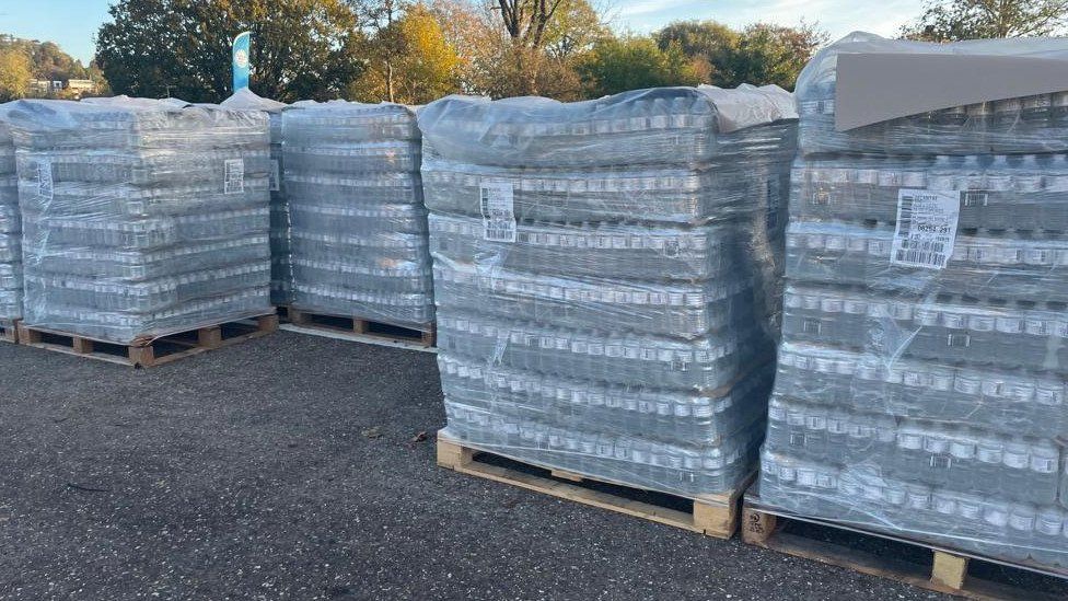 Pallets of water waiting for collection