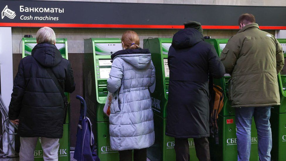 People use Sberbank ATM machines at the Kazansky railway station.