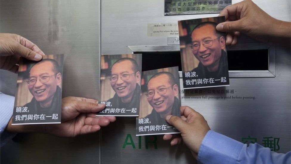 Activists from the Hong Kong Alliance in Support of Patriotic Democratic Movements of China hold some of the one thousand postcards containing messages of support to be sent from the public to Chinese dissident Liu Xiaobo, at the General Post Office, Central District, Hong Kong, China, 05 July 2017.