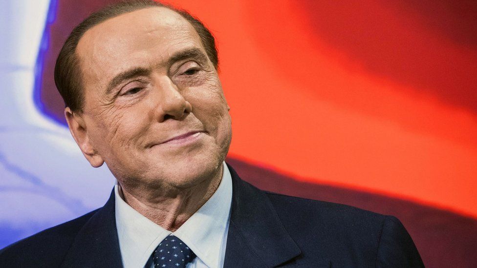 Berlusconi smiles at an event in 2018