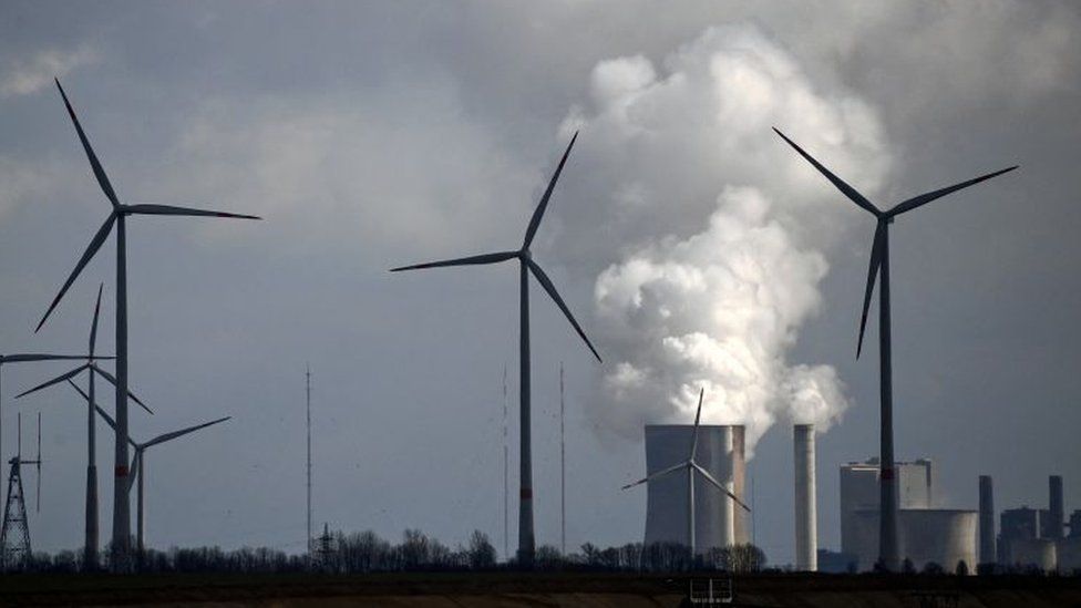 Wind turbines are seen near the coal-fired power station Neurath, Germany