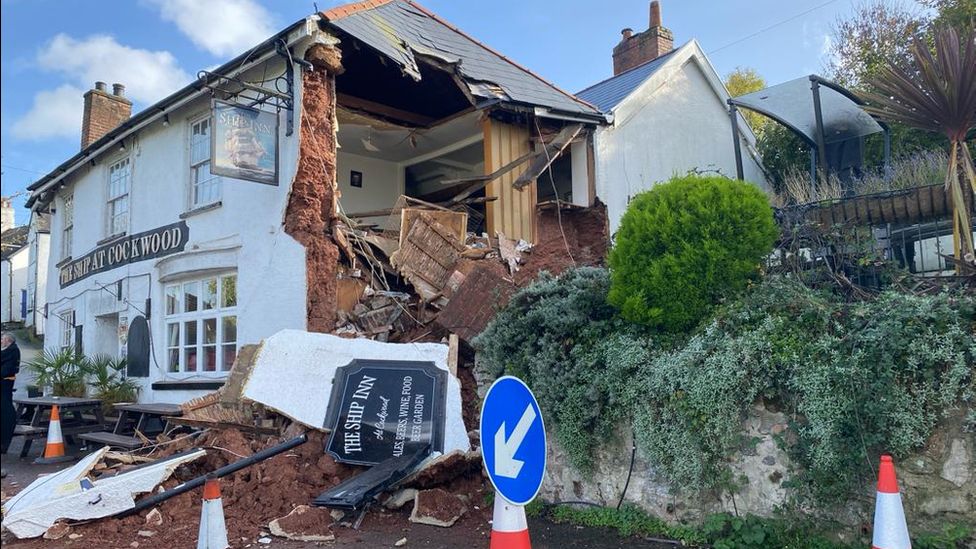 Pub with wall missing and collapsed on the road