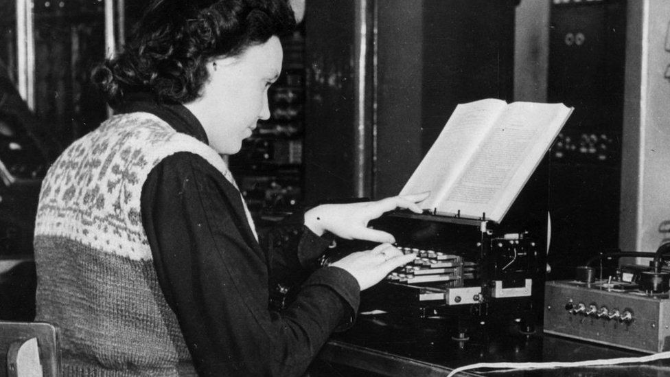 Woman types at a typewriter