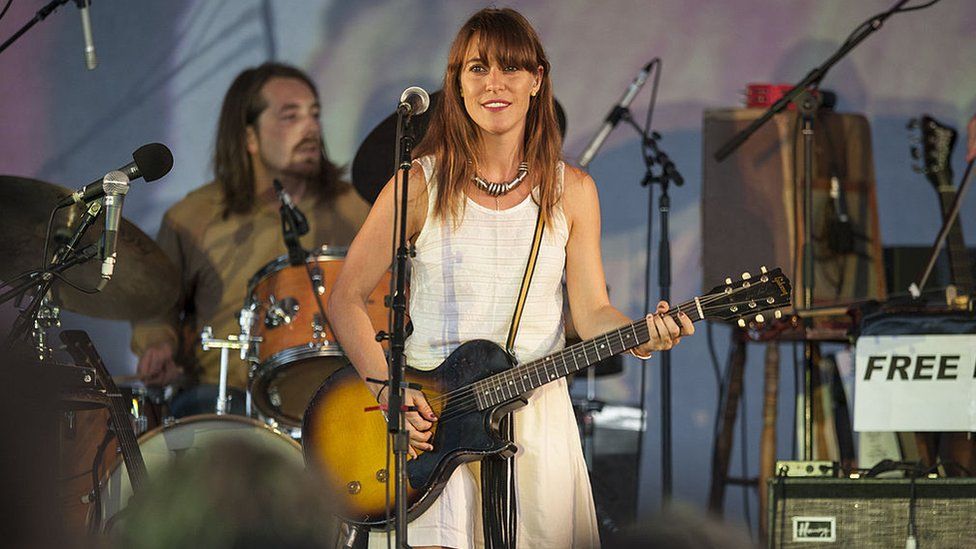 Feist playing onstage during a festival