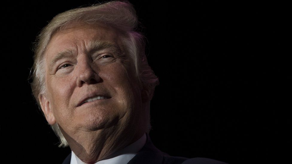 US President-elect Donald Trump looks on while speaking during a 'Thank You Tour 2016' rally in Orlando, Florida on December 16, 2016.