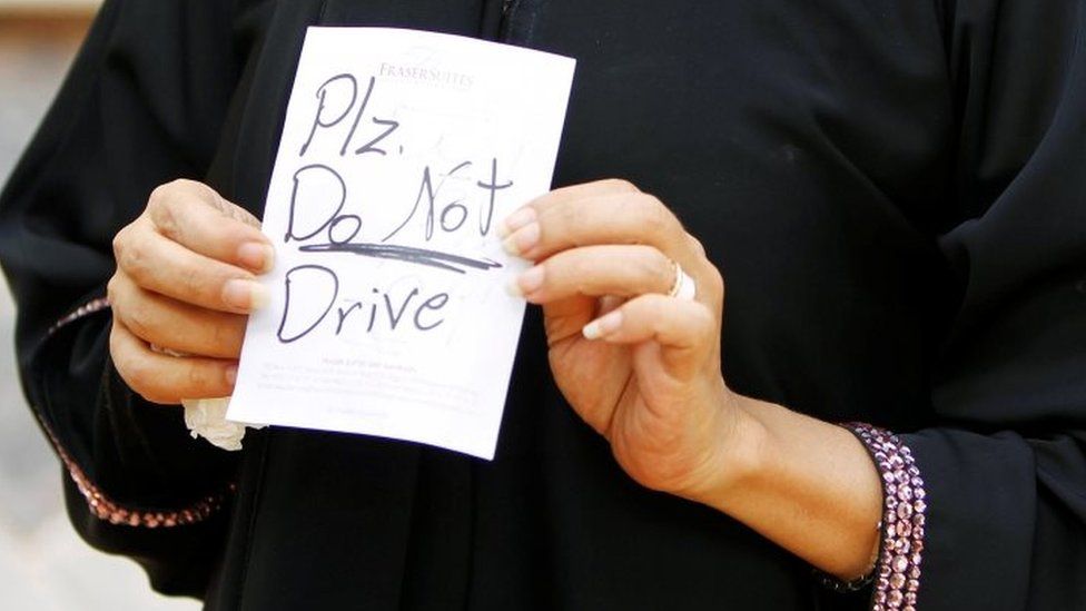 Female driver Azza al-Shmasani displays a note, which according to her, was placed on her car by an unknown person, in Saudi Arabia (22 June 2011`)