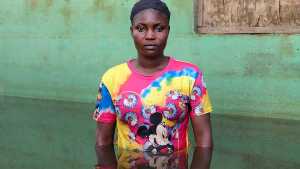 Shiphrah Timbiri standing in flood water in Ogbia Municipality, Bayelsa State, Nigeria - November 2022