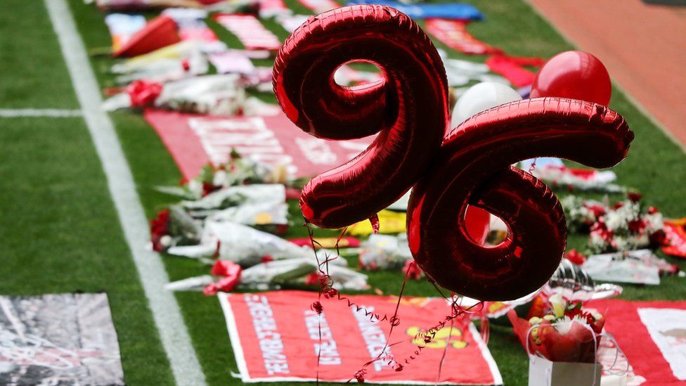 Tributes left on the pitch at Anfield during Friday's service