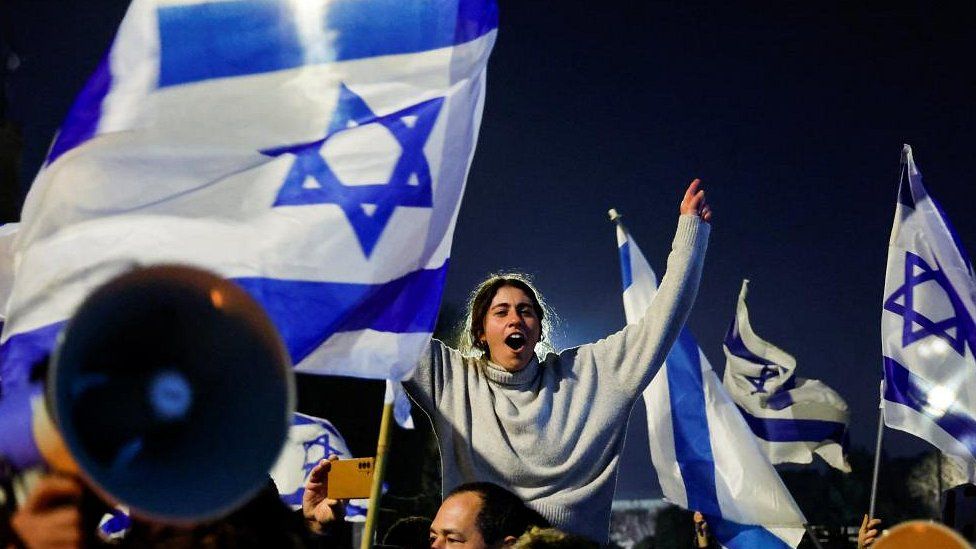 People attend a demonstration after Israeli Prime Minister Benjamin Netanyahu dismissed the defense minister