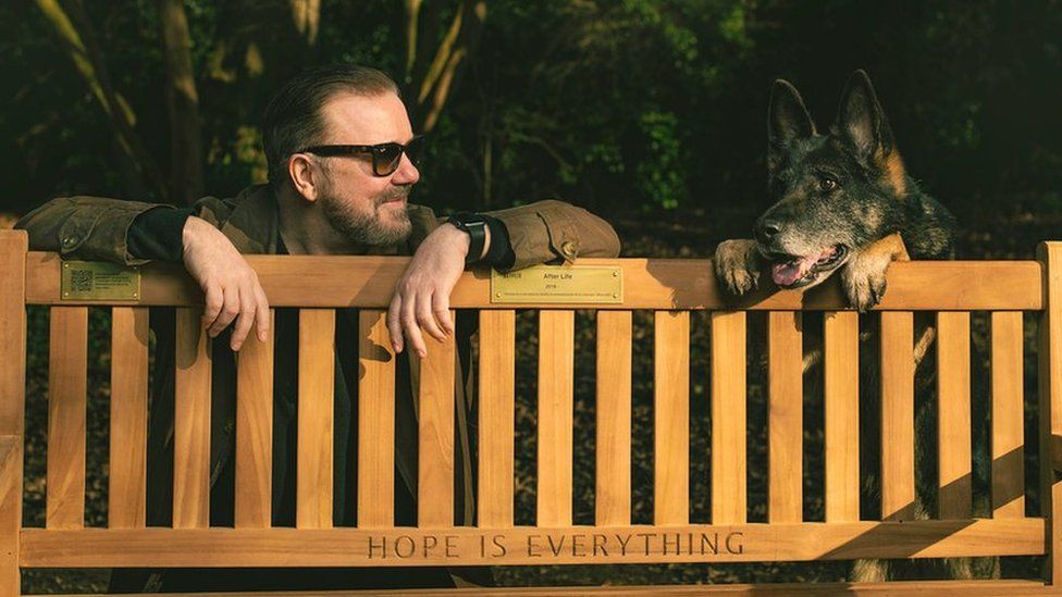 Ricky Gervais and dog with bench