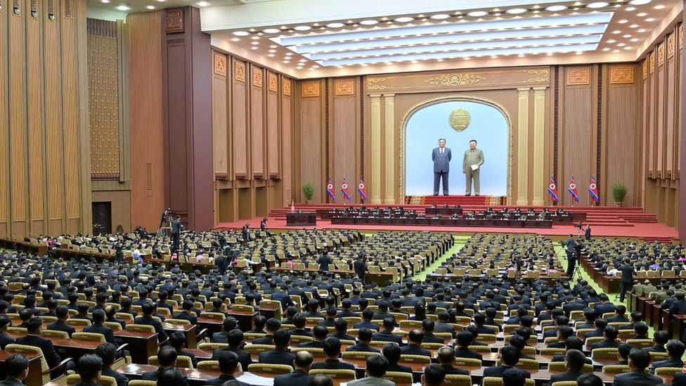 Kim Jong Un at a lectern addresses the Supreme People's Assembly legislators on 15/1