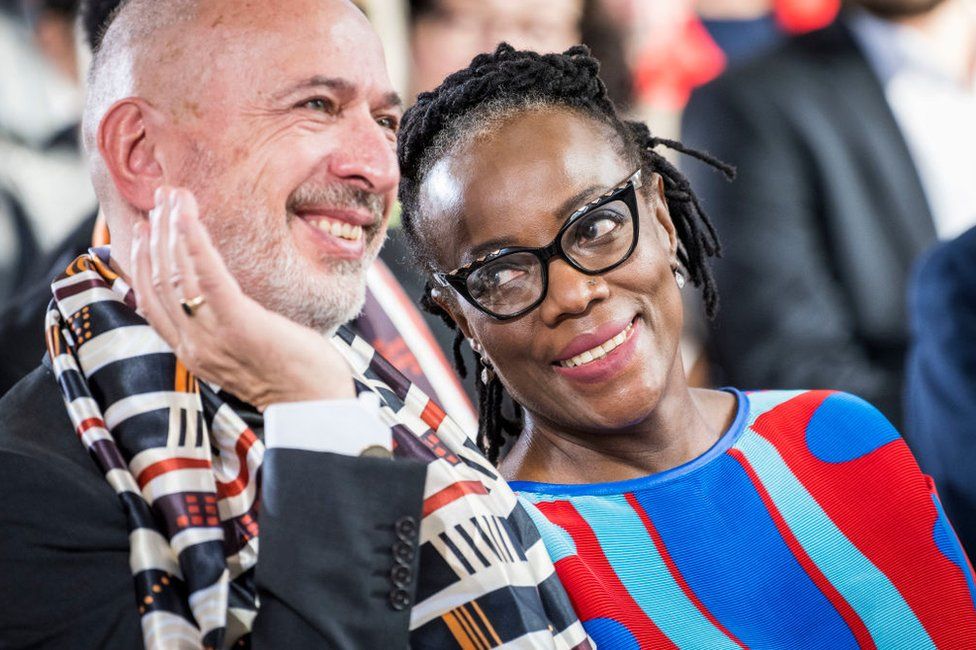 Tsitsi Dangarembga and her husband Olaf Koschke chat and smile.