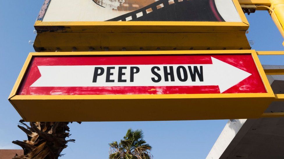 Showgirl's 'Peep Show' sign with arrow