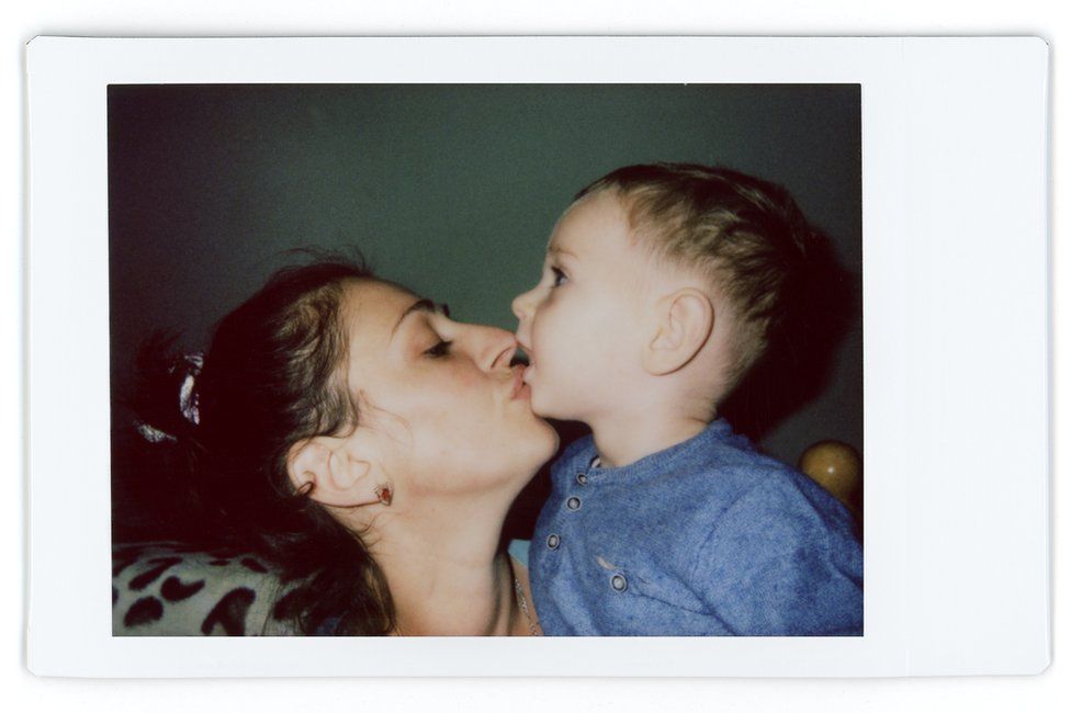 A polaroid photo of Alina and her son