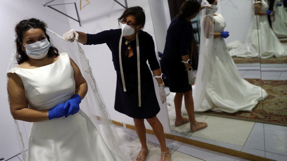 Two women in a bridal store wearing facemasks