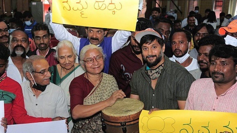 Social activist Medha Patkar (C-L) along with actor and activist Chetan Kumar (C-R) symbolically start a protest meeting by beating a drum in Bangalore on January 14, 2022, while participating in a protest against the governments proposal to construct the Mekedatu reservoir-cum-drinking water project in Karnataka which according to activists and environmentalists it will submerge over 12,000 acres of forests and other lands.