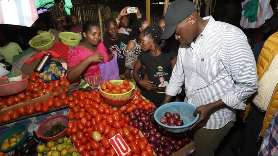 Nairobi gubernatorial candidate Johnson Sakaja buys onions from a vendor