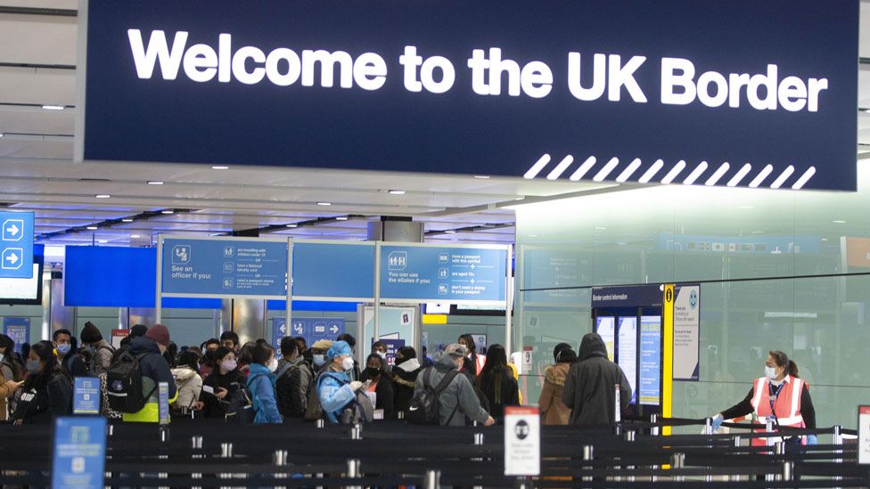 People queue at UK border control at Terminal 2 at Heathrow Airport on 11 February 2021 in London, England