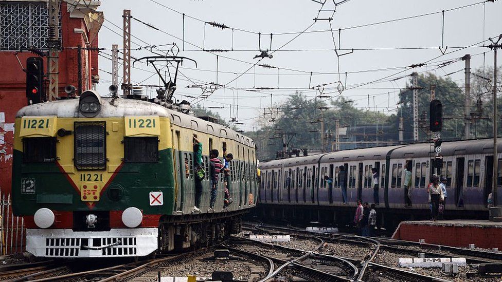 Indian commuter trains run by Sealdah Station in Kolkata on February 25, 2016,
