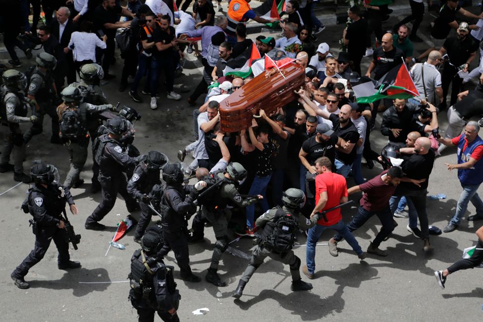 Israeli police clash with mourners as they carry the coffin of slain Al Jazeera journalist Shireen Abu Akleh during her funeral in east Jerusalem, 13 May 2022.