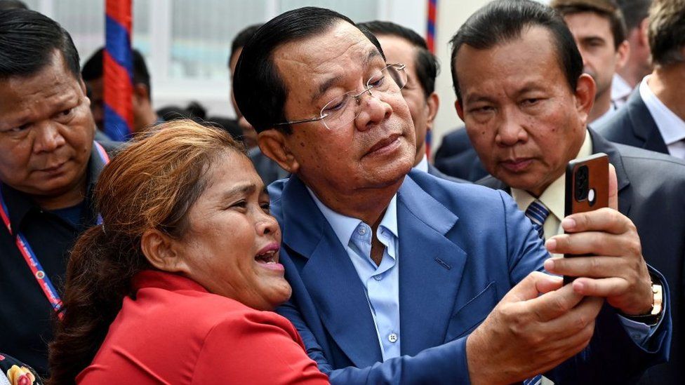 Cambodian Prime Minister leader Hun Sen takes a selfie with a supporter in Phnom Penh