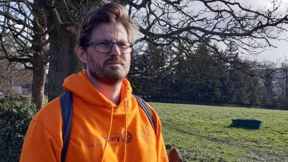 Simon Kitchen, the CEO of Bipolar UK, walking Hadrian's Wall