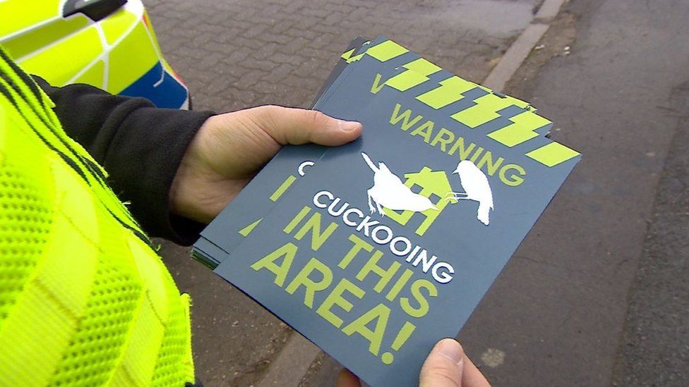 Cuckooing leaflets held in the hand of a police officer