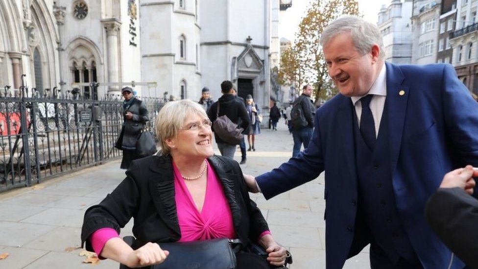Liberal Democrat president Sal Brinton and SNP Westminster leader Ian Blackford outside London's High Court