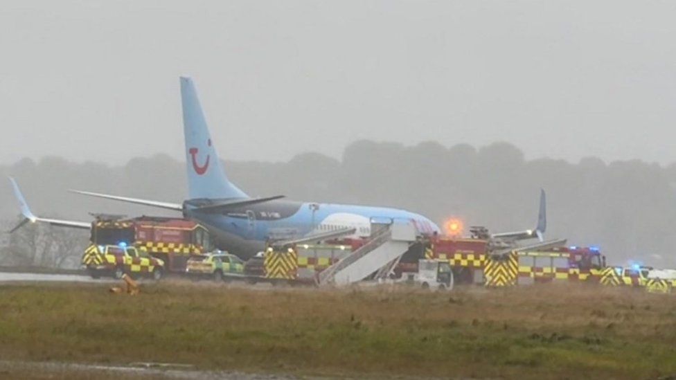 Plane surrounded by emergency services on runway at Leeds Bradford Airport