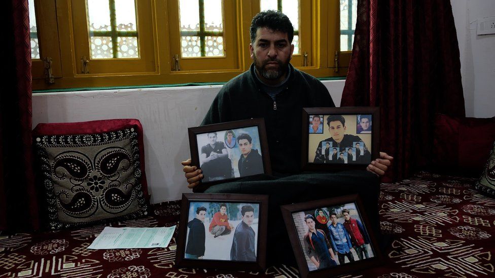 Mushtaq Ahmad Wani showing photos of his teenage son, who was killed in Dec 2020.
