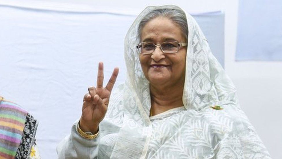 Bangladeshi Prime Minister Sheikh Hasina (R) flashes the victory symbol after casting her vote, as her daughter Saima Wazed Hossain (1st L) and her sister Sheikh Rehana (2nd L) look on at a polling station in Dhaka on December 30, 2018