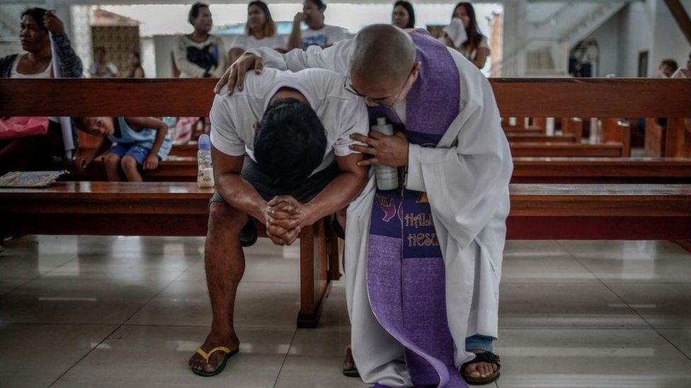 Allan Pineda weeps inconsolably during the funeral of his 13-year-old son Aldrin, who was shot to death by a police officer, in Manila, Philippines, March 14, 2018.