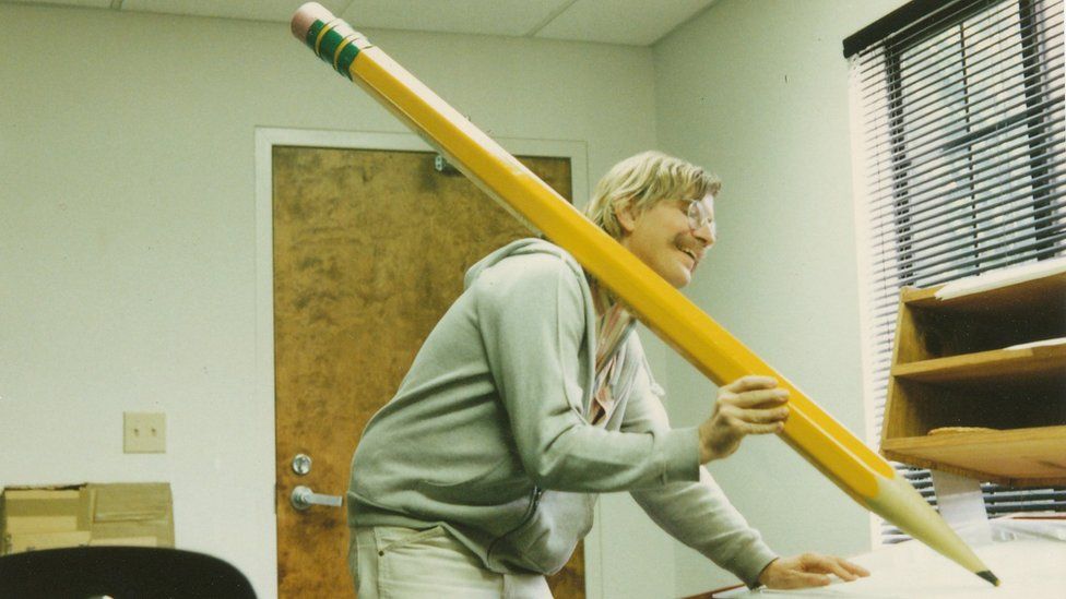 Mark holds a giant pencil during production of Return to Neverland short