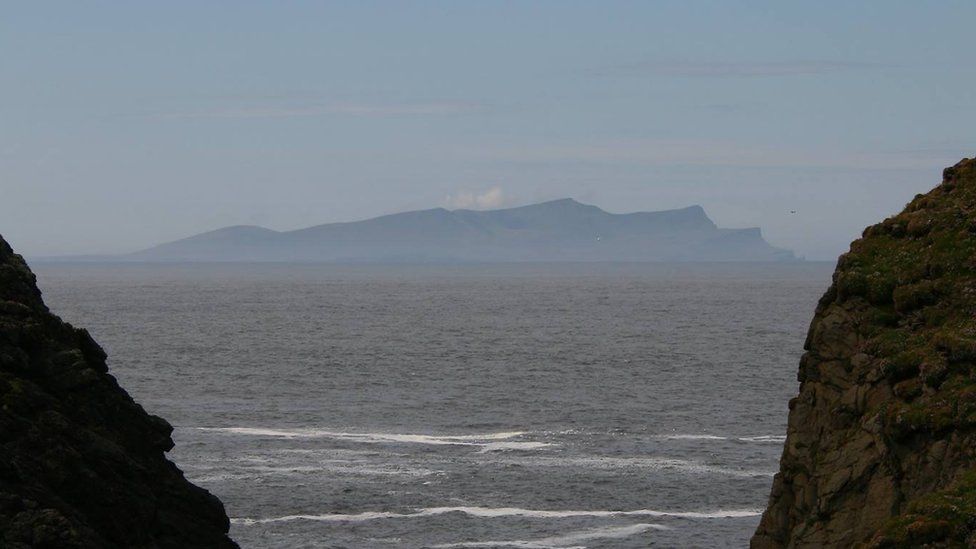 Foula seen between two cliffs