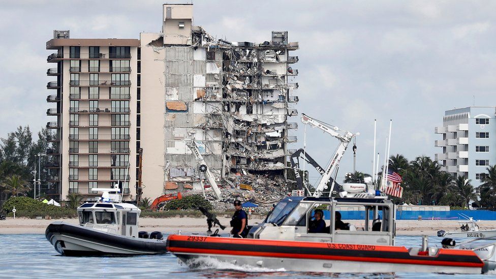 US Coast Guard and Miami-Dade Police patrol at the site of a partially collapsed residential building in Surfside, Florida