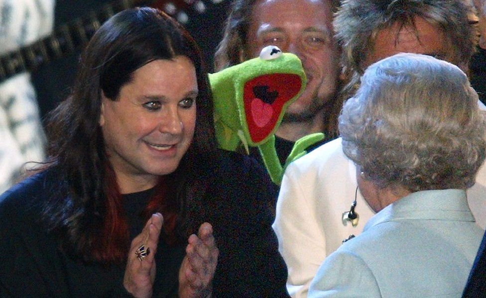 The Queen is introduced to Ozzy Osbourne and Kermit the Frog on stage during "Party at the Palace" in London 03 June 2002