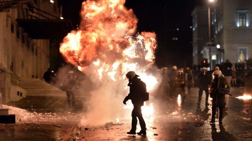A petrol bomb explodes next to riot police in Athens. Photo: 7 November 2012