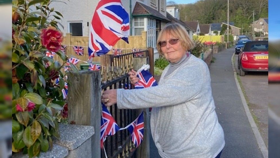 Denise Sage putting up Union Jack bunting in Porlock