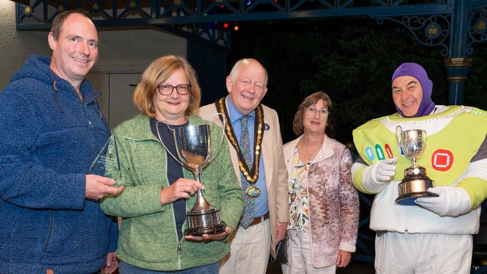 First place to the Motley Bunch, from left Richard Wood, Christine Dence and Pete Hartshorn, pictured with Councillor David Burton and his wife Ruth Burton