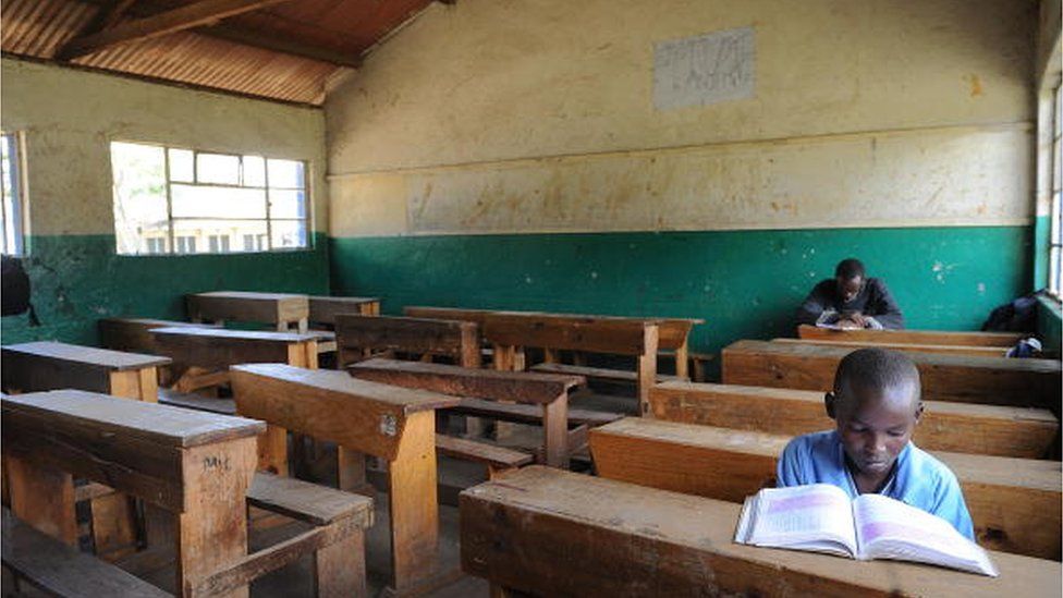 Pupils of the St. Paul Primary School in Nairobi sit in an empty classroom on January 26, 2009, after the school closed, entering its second week in a dispute about teacher's pay.