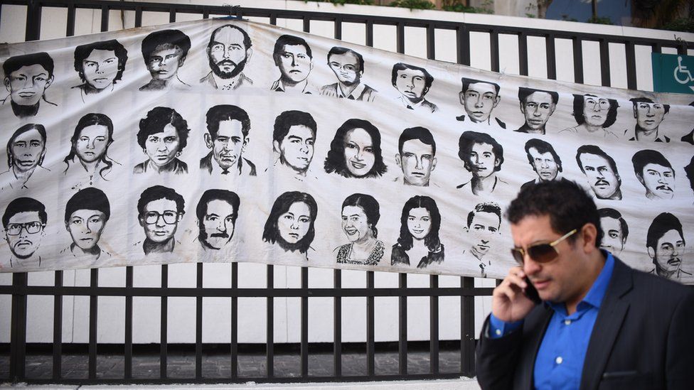 Banner with portraits of disappeared Guatemalans