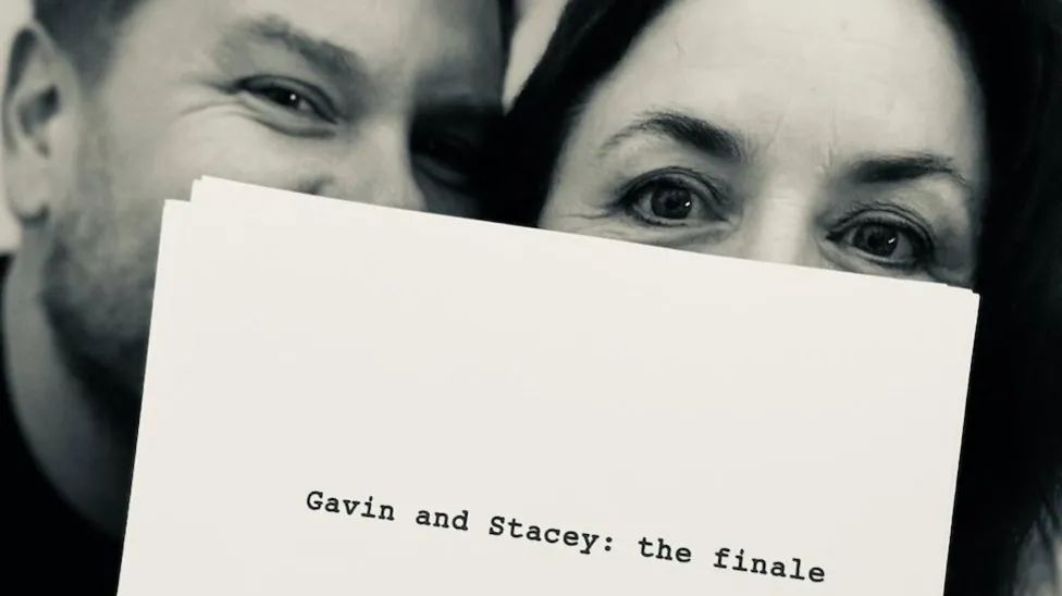 James Corden and Ruth Jones hiding behind the front cover of the script