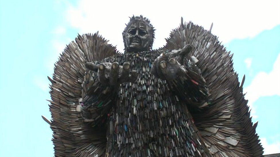 Angel figure with wings made up of thousands of knives